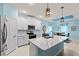 Modern kitchen with white cabinets, a large island, and stainless steel appliances at 1890 Sunset Preserve Way, Port Charlotte, FL 33953