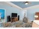 Bright living room with light blue walls and a ceiling fan at 1890 Sunset Preserve Way, Port Charlotte, FL 33953