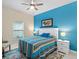 Main bedroom with blue accent wall and patterned bedding at 1890 Sunset Preserve Way, Port Charlotte, FL 33953