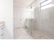 Bright bathroom showcasing a glass-enclosed shower and tile flooring at 1912 Saddlewood Cir, Port Charlotte, FL 33953