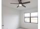Bright bedroom features tiled floors, a ceiling fan, and a large window at 1912 Saddlewood Cir, Port Charlotte, FL 33953