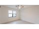 Bright bedroom features tiled floors, a ceiling fan, and a large window at 1912 Saddlewood Cir, Port Charlotte, FL 33953