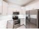 Modern kitchen with stainless steel appliances, granite countertops, and white cabinetry at 1912 Saddlewood Cir, Port Charlotte, FL 33953