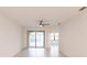 This spacious living room features a ceiling fan and patio access at 1912 Saddlewood Cir, Port Charlotte, FL 33953