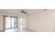 This spacious living room features a ceiling fan and patio access at 1912 Saddlewood Cir, Port Charlotte, FL 33953