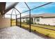 Screened patio with brick pavers and views of the fenced backyard at 1912 Saddlewood Cir, Port Charlotte, FL 33953