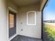 Covered entryway features neutral walls, gray pavers, and a screen showcasing view of the outdoors at 1912 Saddlewood Cir, Port Charlotte, FL 33953