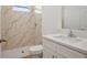 Bathroom with tiled walk-in shower, a toilet, and a white vanity with a mirror at 2143 S Haberland Blvd, North Port, FL 34288
