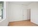 Bedroom with wood-look flooring, bright walls, and a window at 2143 S Haberland Blvd, North Port, FL 34288
