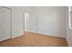 Bedroom with bright walls, wood-look floors, closet, and an open door at 2143 S Haberland Blvd, North Port, FL 34288