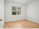 Bedroom with wood-look flooring, bright walls, and a window with a view at 2143 S Haberland Blvd, North Port, FL 34288