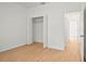 Bedroom with wood-look flooring, bright walls, and a closet at 2143 S Haberland Blvd, North Port, FL 34288