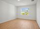 Bedroom featuring wood floors, bright natural light, and a spacious, minimalist aesthetic at 2143 S Haberland Blvd, North Port, FL 34288