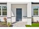 Close-up of the home's entrance showing a stylish front door and inviting landscaping, enhancing curb appeal at 2143 S Haberland Blvd, North Port, FL 34288
