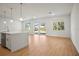 Bright living room with wood floors, large windows and sliding glass doors leading to the outdoors at 2143 S Haberland Blvd, North Port, FL 34288