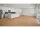 Open floor plan with wood floors, white walls and kitchen island provides a perfect space to relax at 2143 S Haberland Blvd, North Port, FL 34288