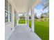 Covered patio with white columns overlooking a spacious yard at 2143 S Haberland Blvd, North Port, FL 34288