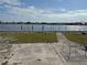 Spacious backyard with canal view and partially shaded patio; tables and chairs at 21535 Edgewater Dr, Port Charlotte, FL 33952