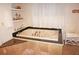 Bathroom featuring a jetted tub with tile surround and elegant fixtures at 21535 Edgewater Dr, Port Charlotte, FL 33952