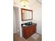 Bathroom vanity with a dark countertop and traditional wood cabinetry at 21535 Edgewater Dr, Port Charlotte, FL 33952