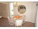 Cozy dining area with round table and chairs, featuring a unique chandelier at 21535 Edgewater Dr, Port Charlotte, FL 33952