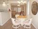 Dining area with seating for four and views into the living room and kitchen at 21535 Edgewater Dr, Port Charlotte, FL 33952