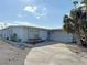Charming single Gathering home with well-maintained lawn, mature palm trees, and a paved driveway at 21535 Edgewater Dr, Port Charlotte, FL 33952