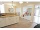 Open-concept kitchen featuring granite countertops, white cabinets, and tile flooring at 21535 Edgewater Dr, Port Charlotte, FL 33952