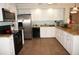 Spacious kitchen featuring stainless steel appliances, white cabinets, and granite countertops at 21535 Edgewater Dr, Port Charlotte, FL 33952