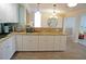 Bright kitchen featuring white cabinetry, granite countertops, and an open layout at 21535 Edgewater Dr, Port Charlotte, FL 33952