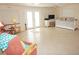 Bright living room featuring tile flooring, ceiling fan, and a cozy seating area at 21535 Edgewater Dr, Port Charlotte, FL 33952