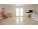 Bright living room with tile floors, ceiling fan, and French doors leading to the patio at 21535 Edgewater Dr, Port Charlotte, FL 33952