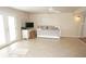 Cozy living area with a daybed, TV, and access to the outdoor area through double doors at 21535 Edgewater Dr, Port Charlotte, FL 33952