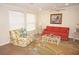 Well-lit living room with comfortable seating, ceiling fan, and decorative artwork at 21535 Edgewater Dr, Port Charlotte, FL 33952