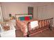 Well-lit bedroom featuring an iron bed frame, neutral walls, and closet at 21535 Edgewater Dr, Port Charlotte, FL 33952