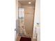 Tiled shower with surf-themed curtain and built-in shower head; neutral tile at 21535 Edgewater Dr, Port Charlotte, FL 33952