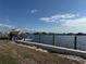 Waterfront property featuring a boat lift, dock, and calm water views at 21535 Edgewater Dr, Port Charlotte, FL 33952