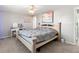 Cozy bedroom with a large bed, ceiling fan, and stylish decor, creating a relaxing space at 21923 Cellini Ave, Port Charlotte, FL 33952
