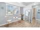 Bright living area with large windows, cozy seating, and view of the bathroom at 21923 Cellini Ave, Port Charlotte, FL 33952