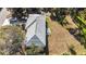 An aerial view of a home with a well-maintained roof and a patio dining set, surrounded by lush greenery at 2325 Hanford Ln, North Port, FL 34288