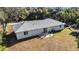 Rear view of home highlighting backyard with patio, table, chairs, and barbecue grill at 2325 Hanford Ln, North Port, FL 34288