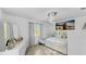 Bright bedroom featuring a large window, modern light fixture, and stylish decor at 2325 Hanford Ln, North Port, FL 34288
