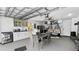 Finished garage features kitchenette, dining table, and lounging area at 2325 Hanford Ln, North Port, FL 34288