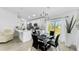 Bright kitchen with white cabinets, island, and dining area at 2325 Hanford Ln, North Port, FL 34288