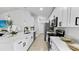 Modern kitchen with white cabinets and stainless steel appliances at 2325 Hanford Ln, North Port, FL 34288