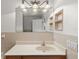 Bathroom featuring a well-lit vanity with a sink, a large mirror, decorative lighting, and tiled walls at 2443 Lake View Blvd, Port Charlotte, FL 33948
