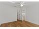 Cozy bedroom with light wood floors, neutral walls, ceiling fan, and white trim at 2443 Lake View Blvd, Port Charlotte, FL 33948