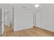 Bright bedroom with light wood flooring, neutral walls, white trim and multiple doors at 2443 Lake View Blvd, Port Charlotte, FL 33948