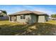 The landscaped backyard includes a screened-in patio at 2443 Lake View Blvd, Port Charlotte, FL 33948