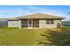 A spacious backyard with a screened-in patio offers tranquil views at 2443 Lake View Blvd, Port Charlotte, FL 33948